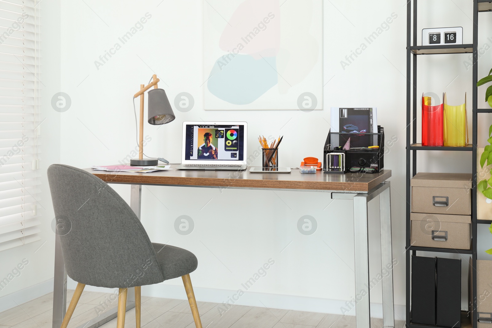 Photo of Fashion designer`s workplace with laptop and different supplies on table