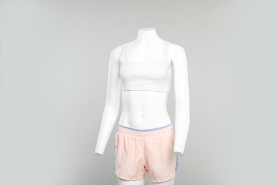 Photo of Female mannequin with stylish sportswear on light background