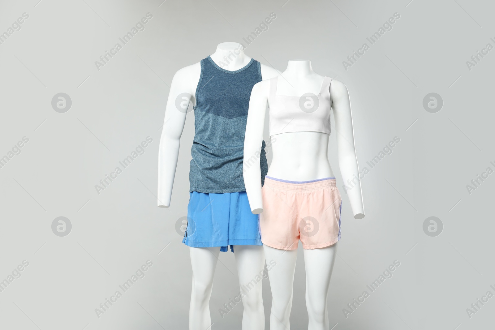 Photo of Female and male mannequins with stylish sportswear on light background