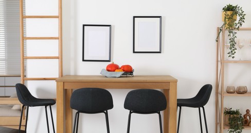 Bar stools near wooden table in room