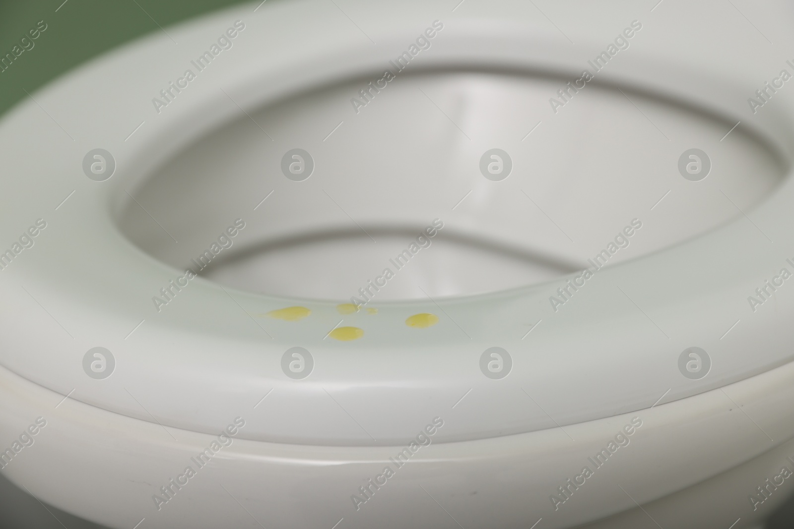 Photo of Urine drops on toilet seat in restroom, closeup