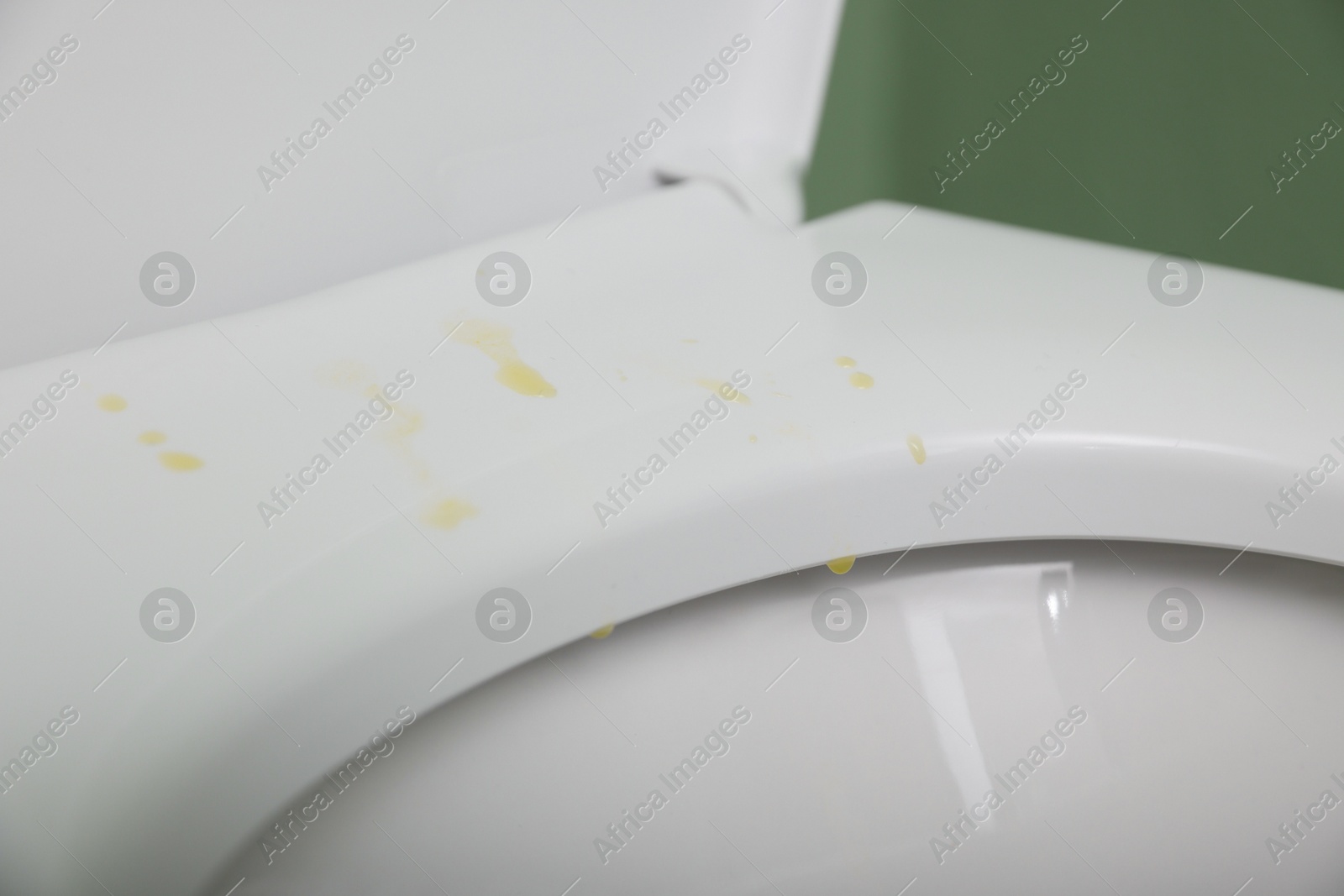 Photo of Urine drops on toilet seat in restroom, closeup