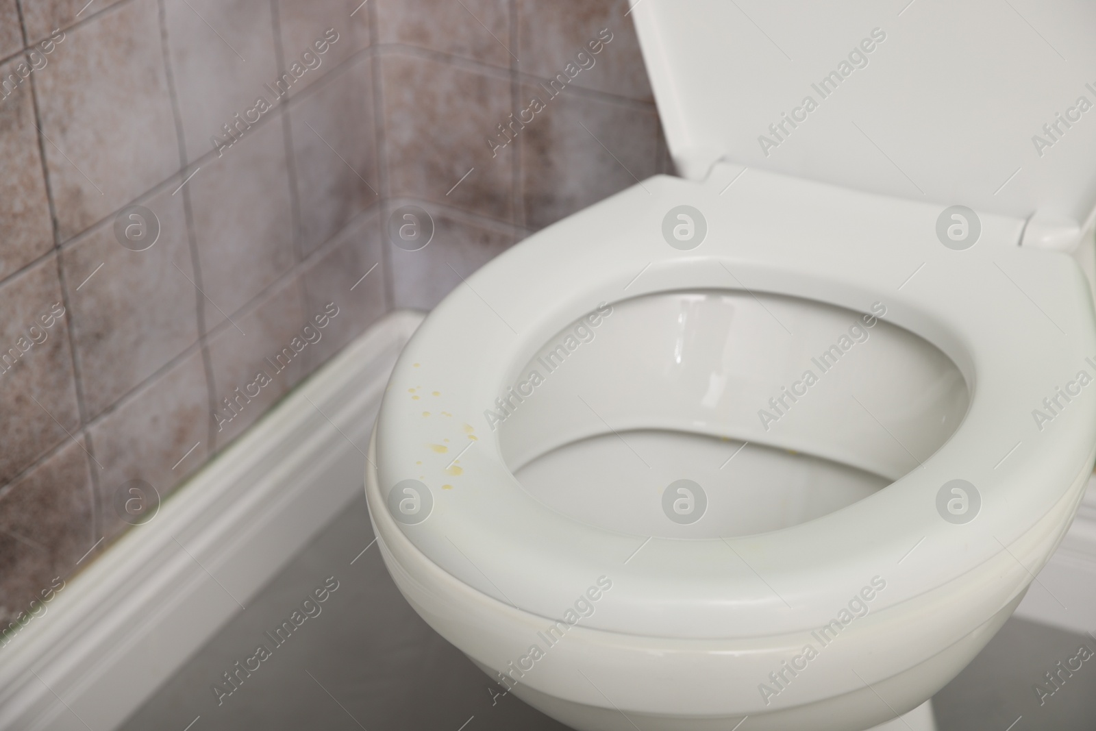 Photo of Urine drops on toilet seat in restroom