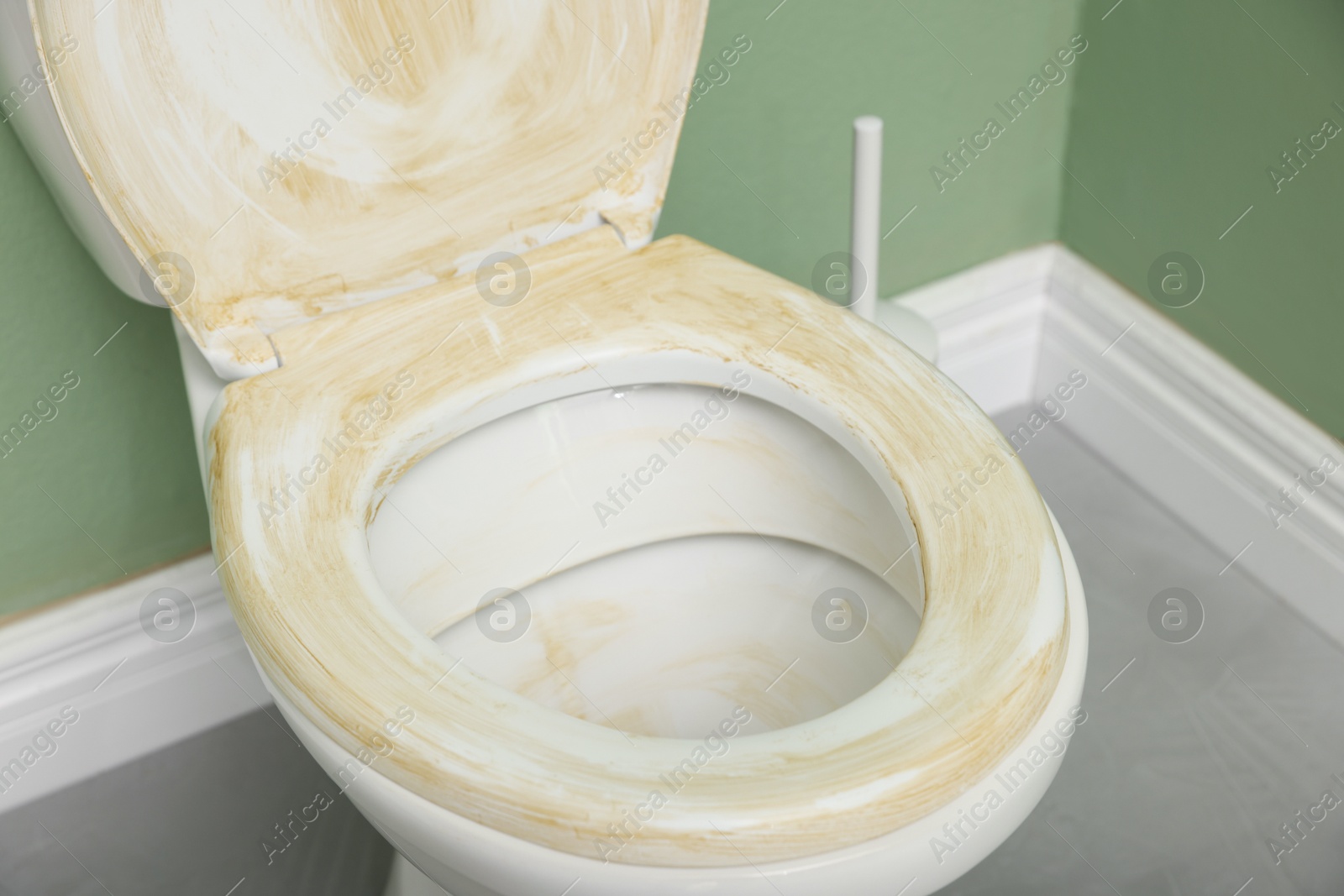 Photo of Toilet with dirty seat in public restroom, closeup