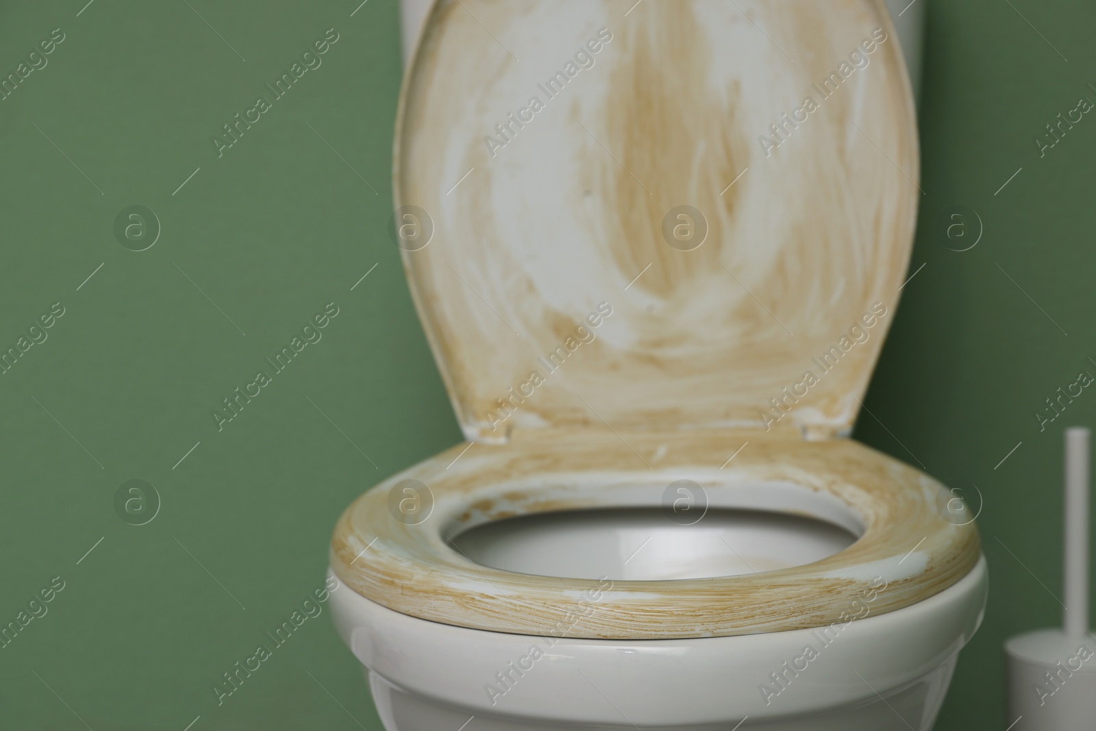 Photo of Toilet with dirty seat in public restroom