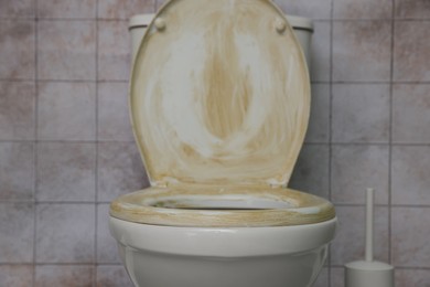 Photo of Toilet with dirty seat in public restroom