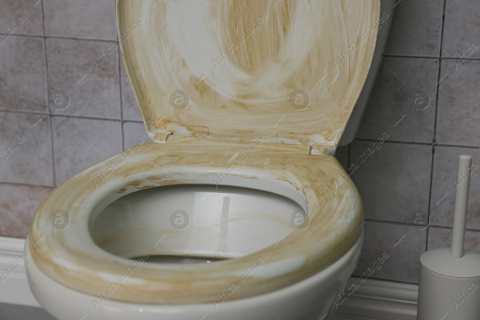 Photo of Toilet with dirty seat in public restroom, closeup