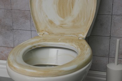 Toilet with dirty seat in public restroom, closeup