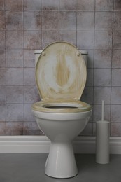 Photo of Toilet with dirty seat in public restroom