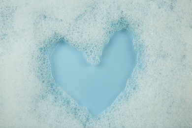 Washing laundry. Water with foam, top view