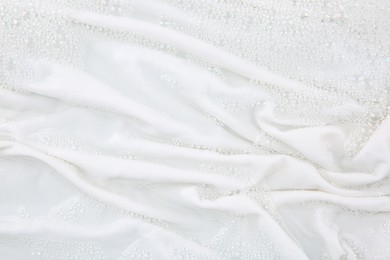 Washing laundry in water with foam, top view