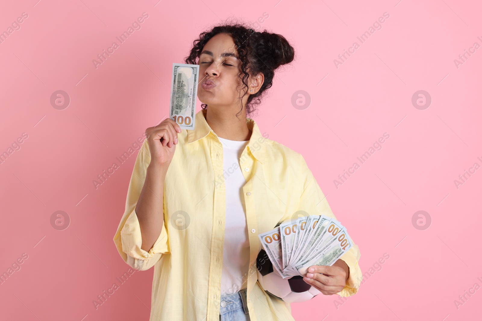 Photo of Woman with money and soccer ball on pink background