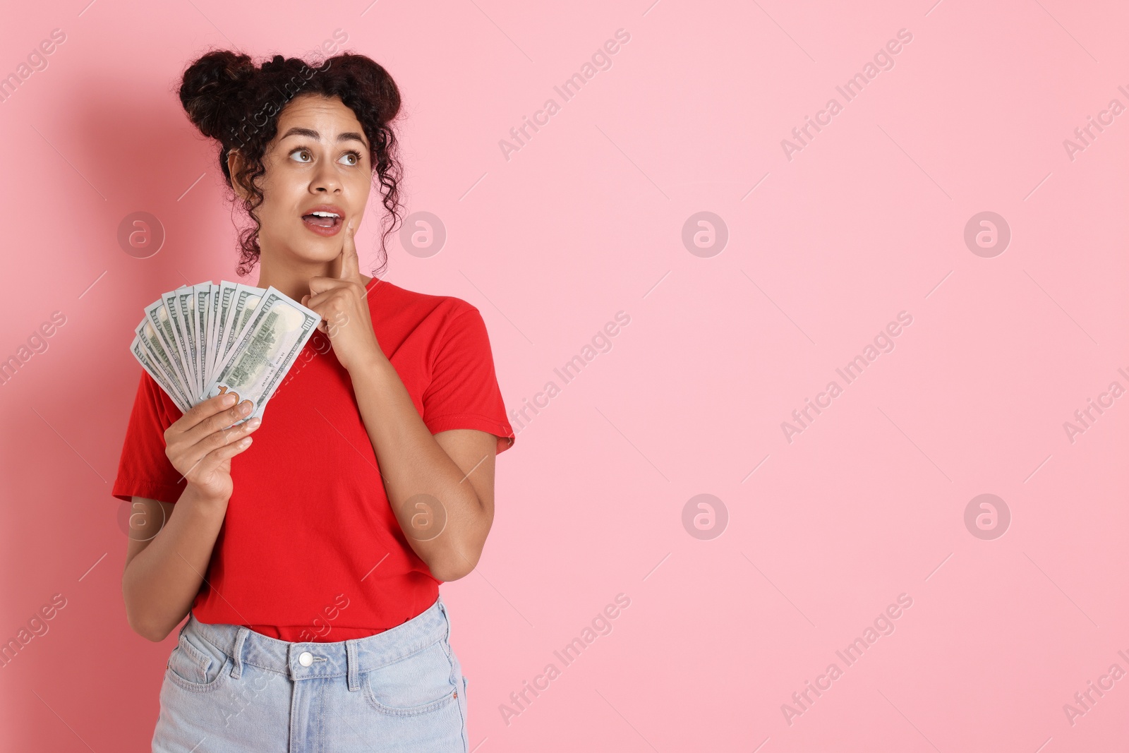 Photo of Woman with dollar banknotes on pink background, space for text