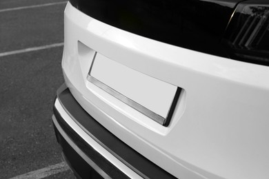 Photo of Closeup view of modern white car parked outdoors