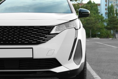 Photo of Closeup view of modern white car parked outdoors