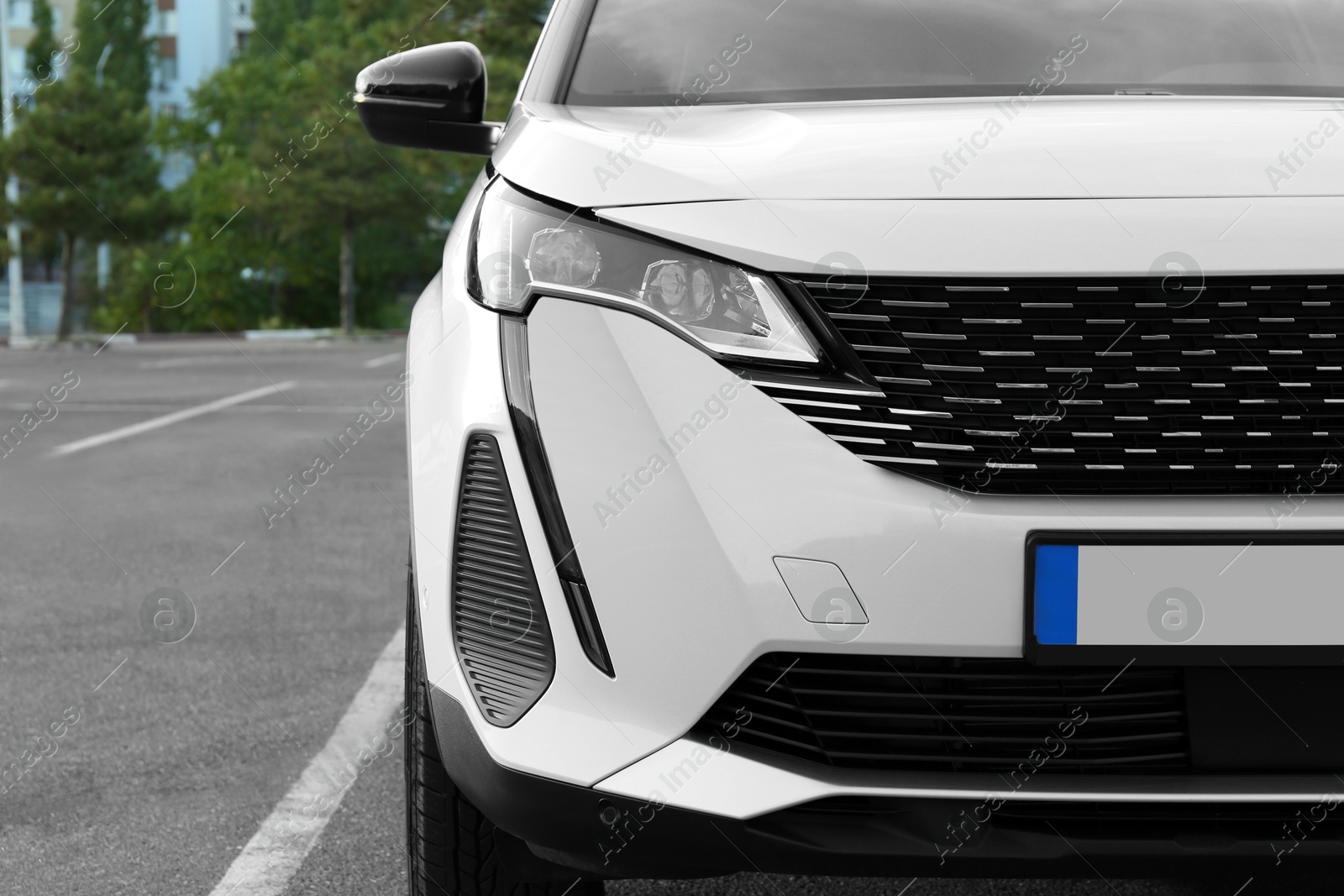 Photo of Closeup view of modern white car parked outdoors