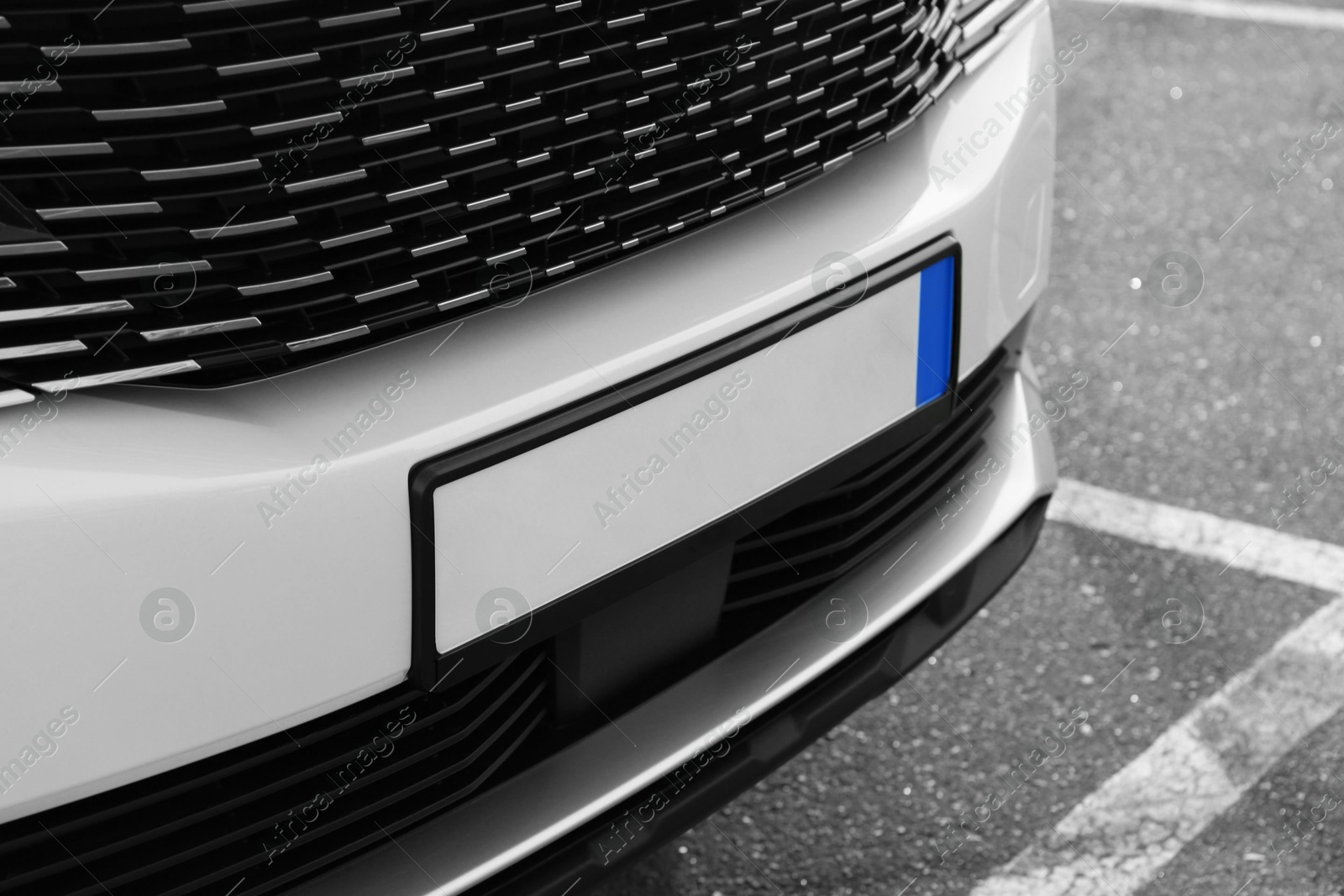 Photo of Closeup view of modern white car parked outdoors