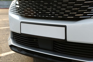 Photo of Closeup view of modern white car parked outdoors