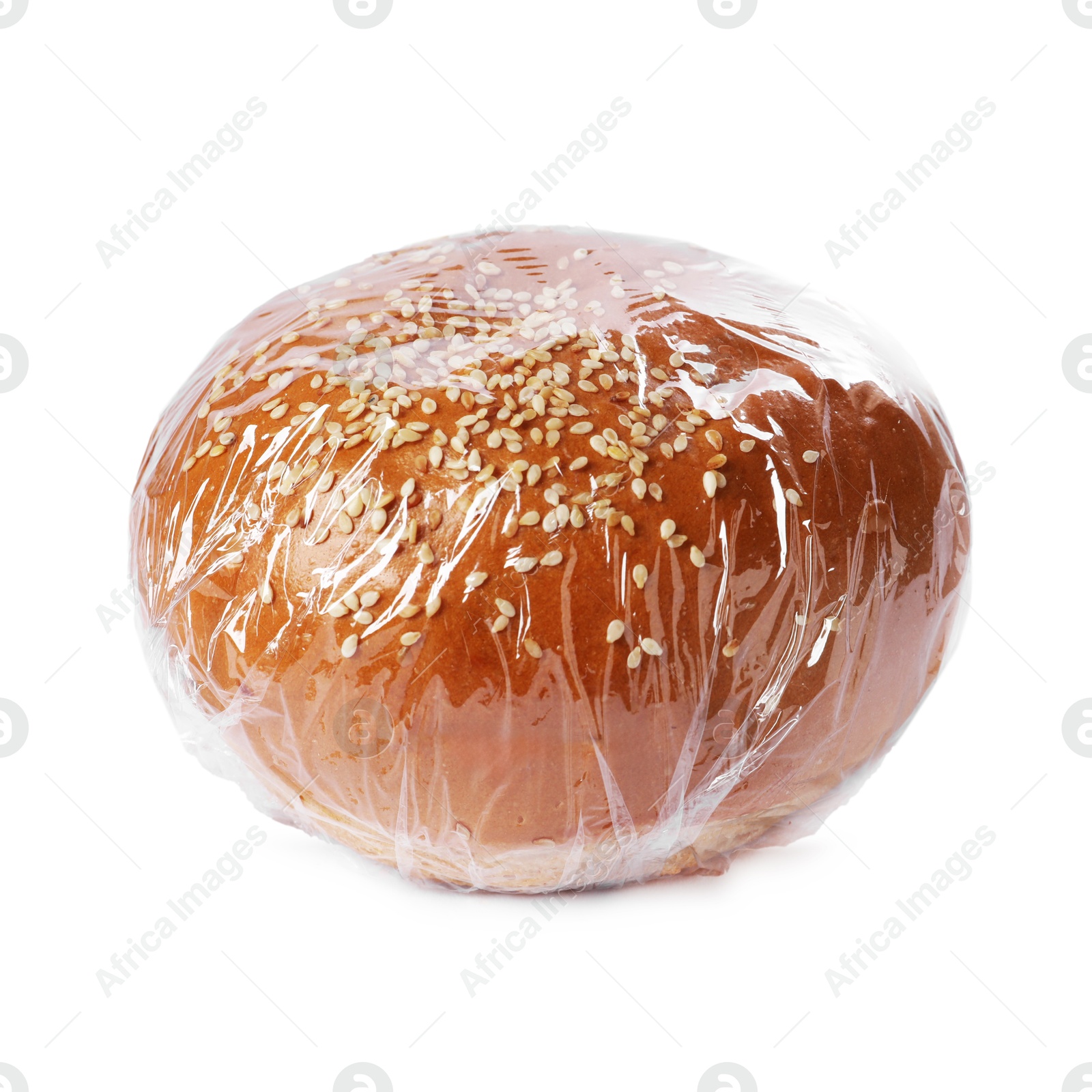 Photo of Fresh bun with plastic food wrap isolated on white