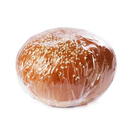 Photo of Fresh bun with plastic food wrap isolated on white