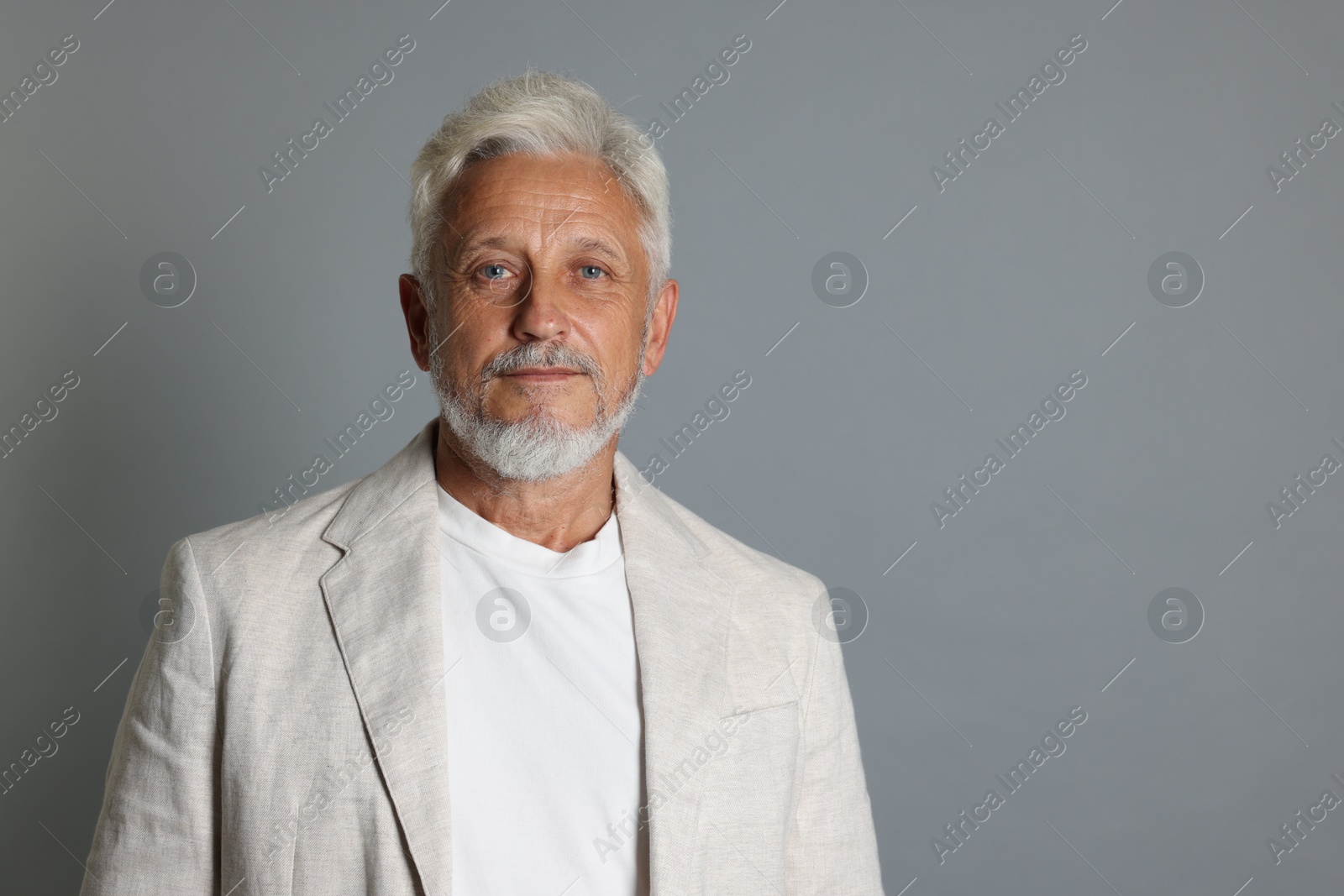 Photo of Portrait of senior man on grey background, space for text