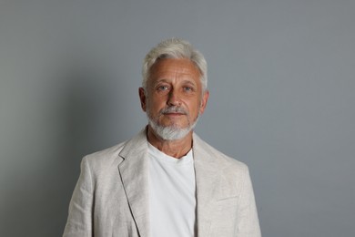 Portrait of senior man on grey background