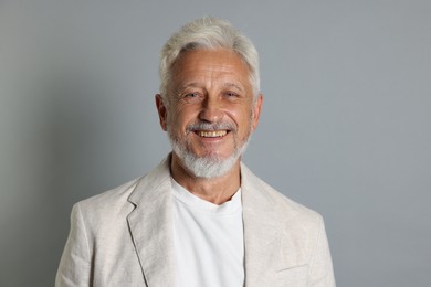 Photo of Portrait of senior man on grey background