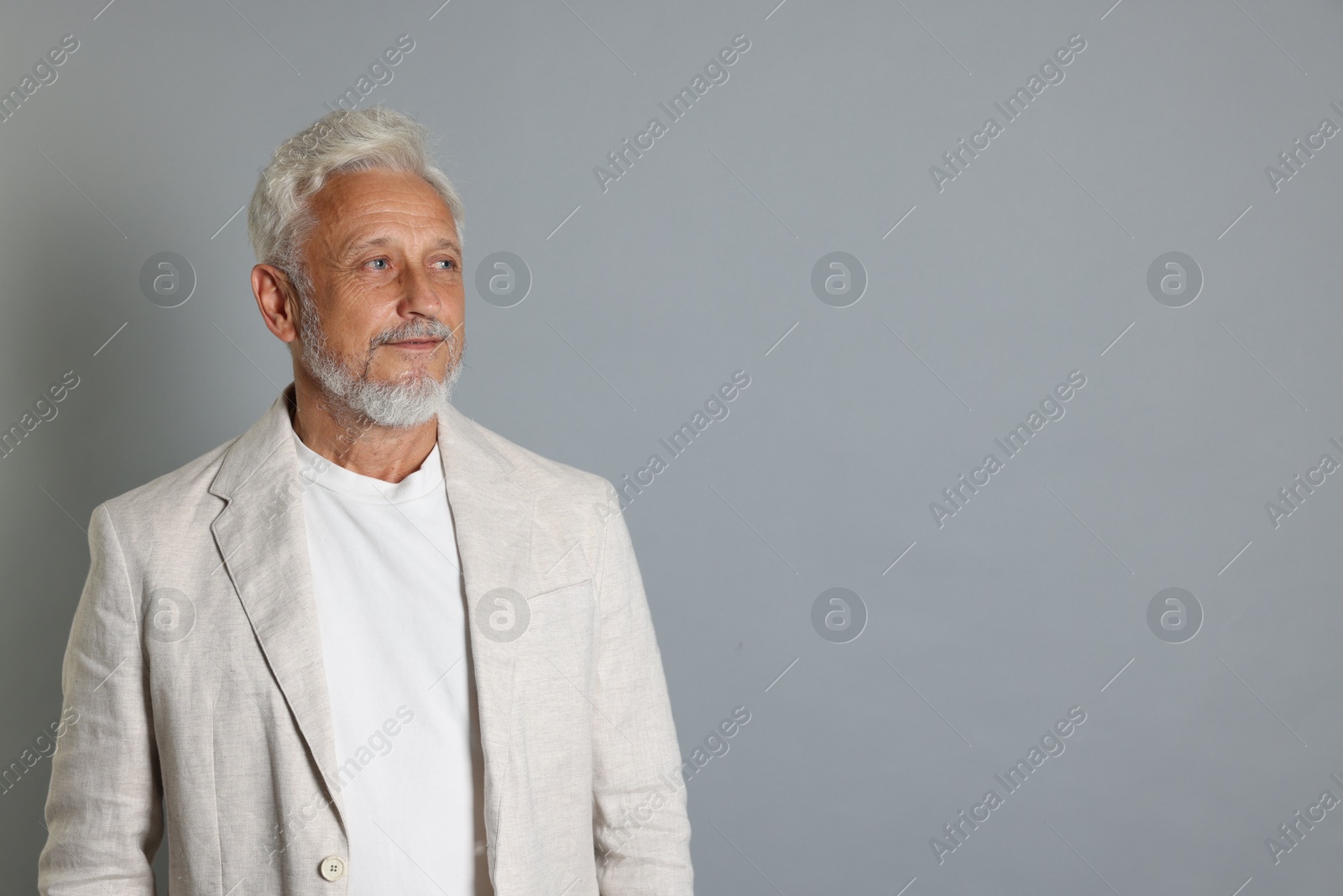 Photo of Portrait of senior man on grey background, space for text