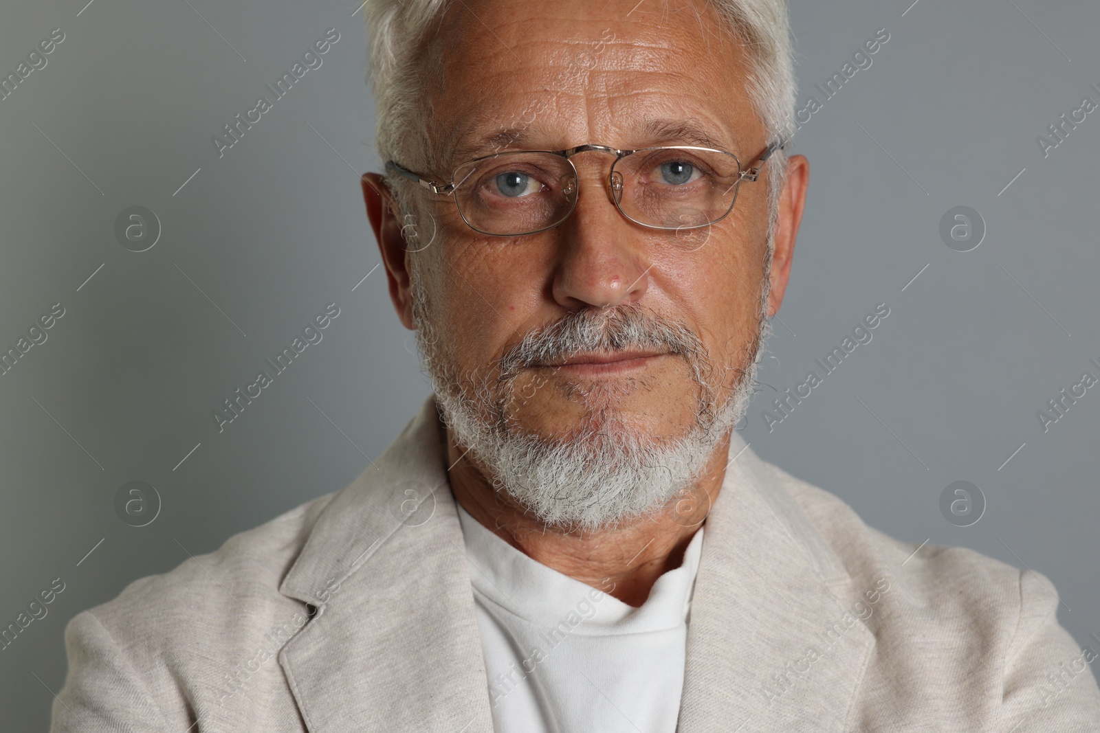 Photo of Portrait of senior man on grey background