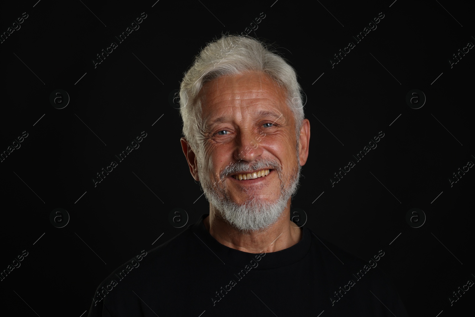 Photo of Portrait of senior man on black background