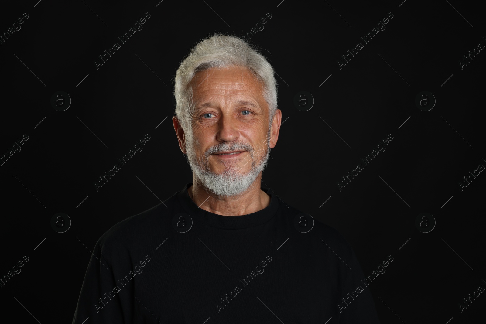 Photo of Portrait of senior man on black background