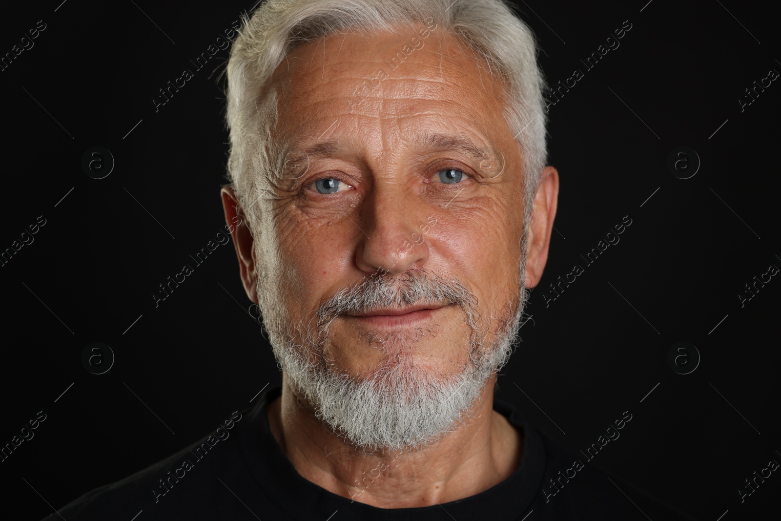 Photo of Portrait of senior man on black background