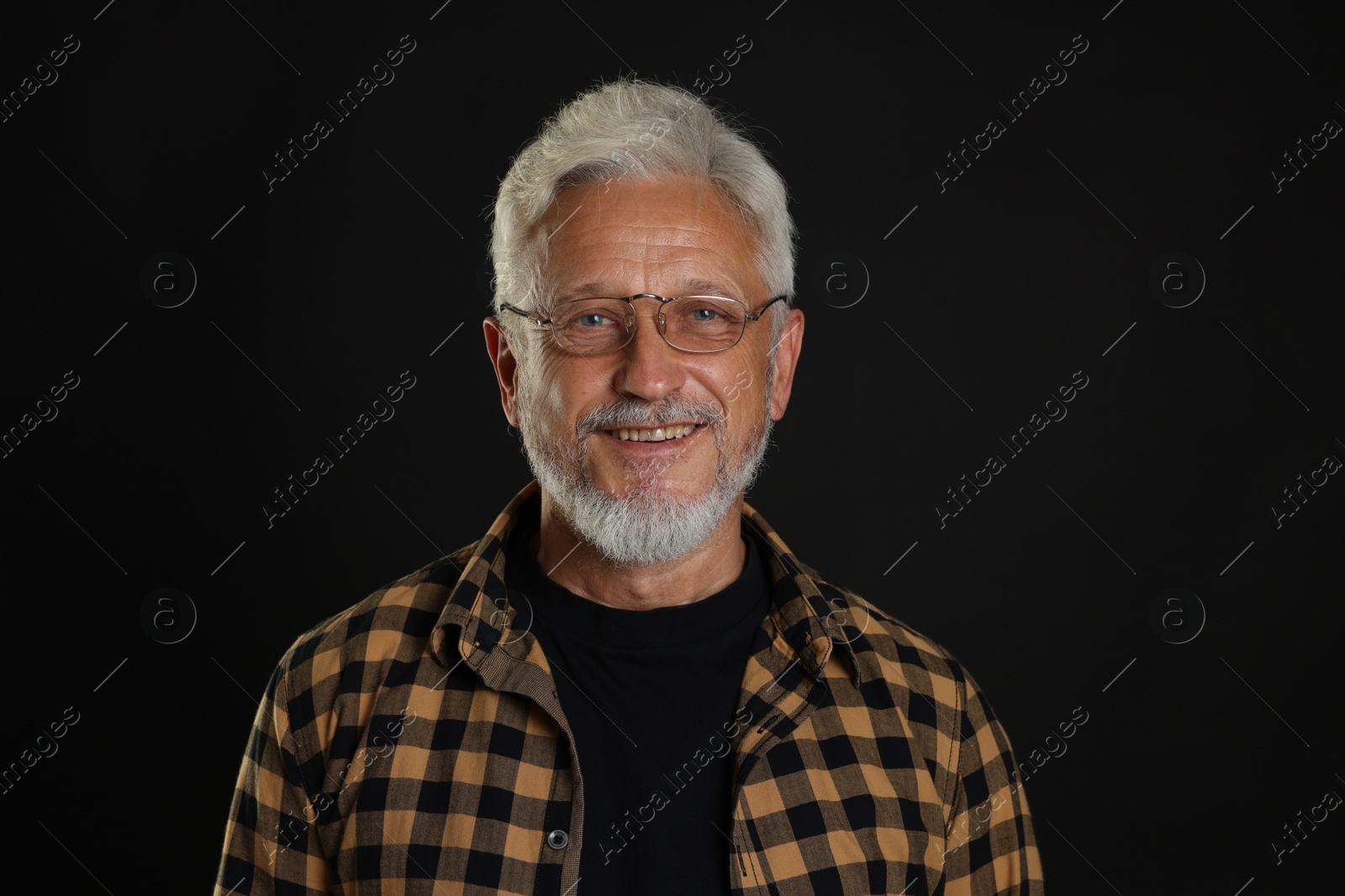 Photo of Portrait of senior man on black background