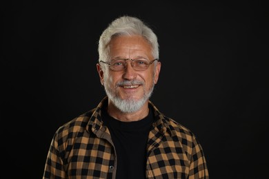 Photo of Portrait of senior man on black background