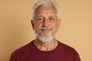 Photo of Portrait of senior man on beige background