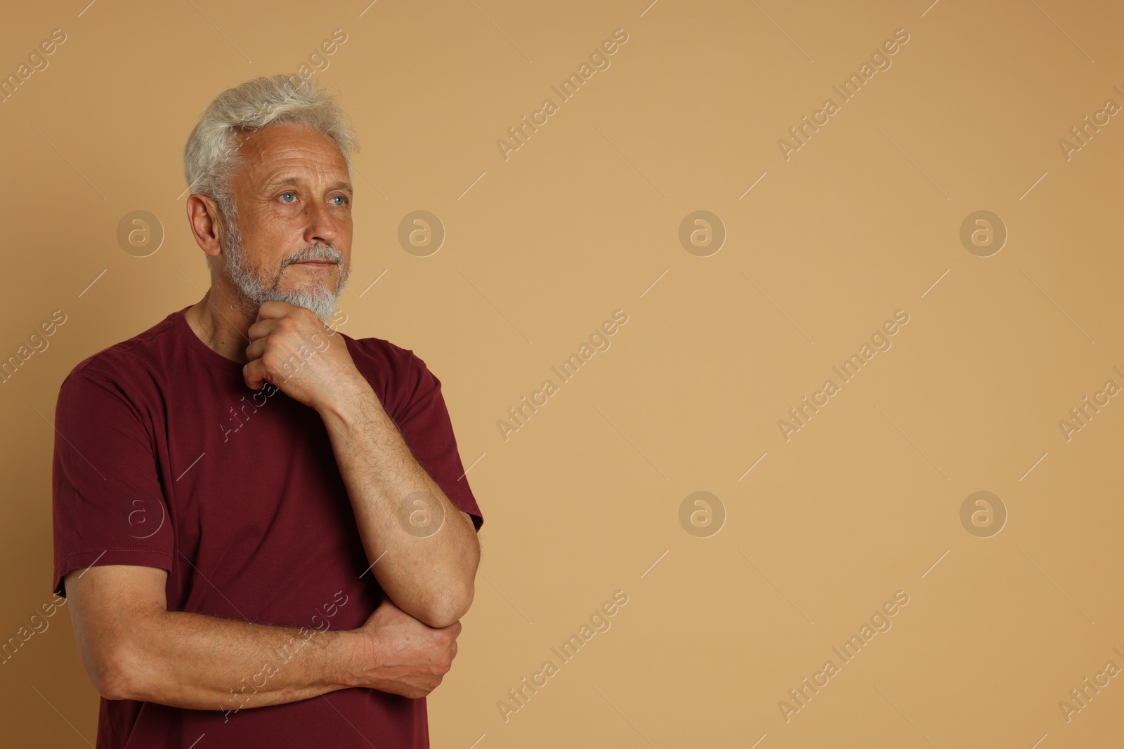 Photo of Portrait of senior man on beige background, space for text