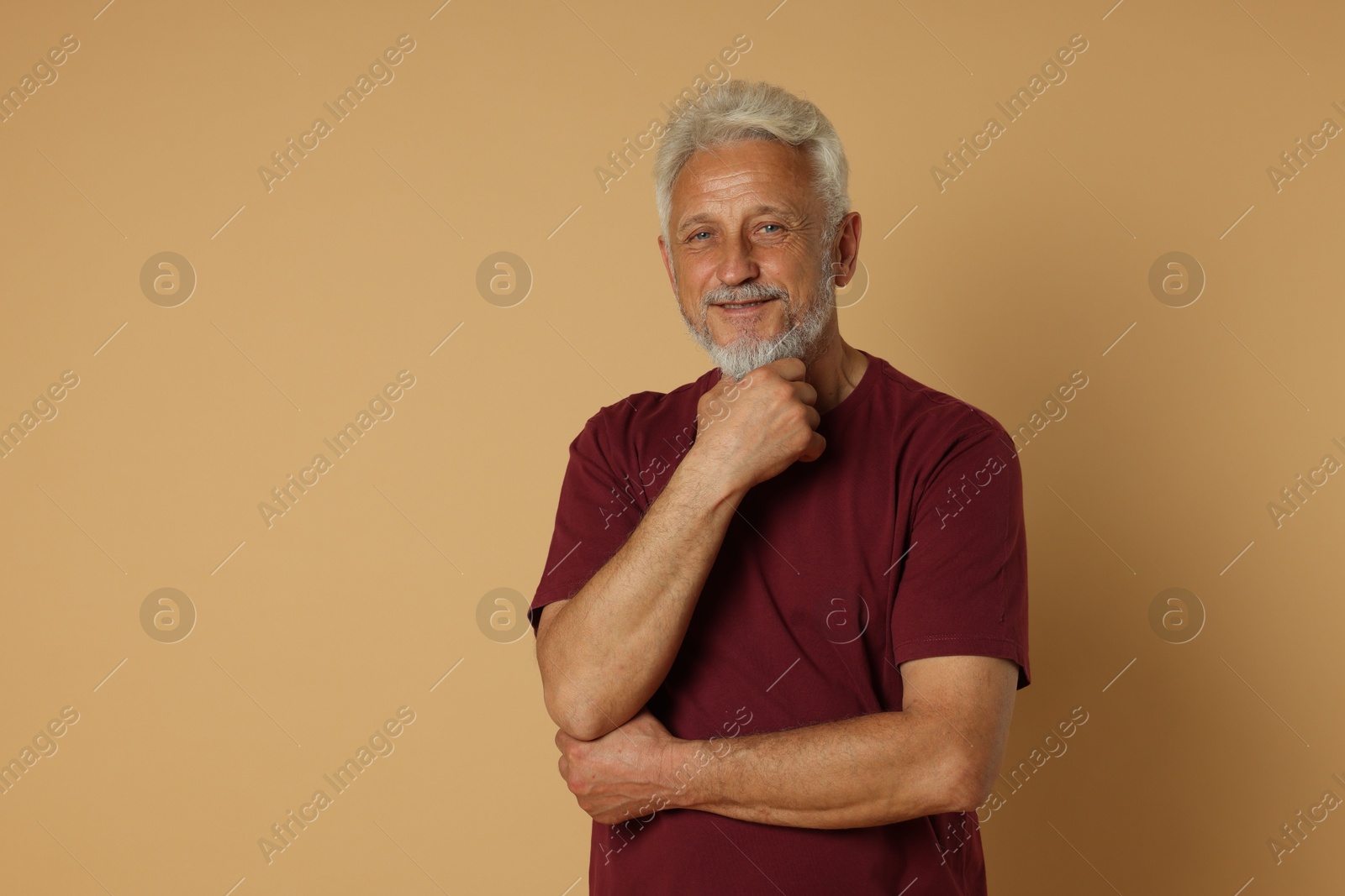 Photo of Portrait of senior man on beige background, space for text