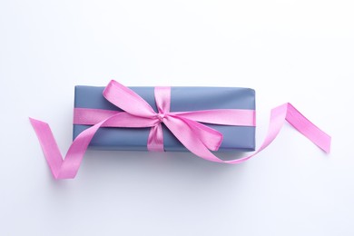 Photo of Beautiful gift box with pink bow isolated on white, top view