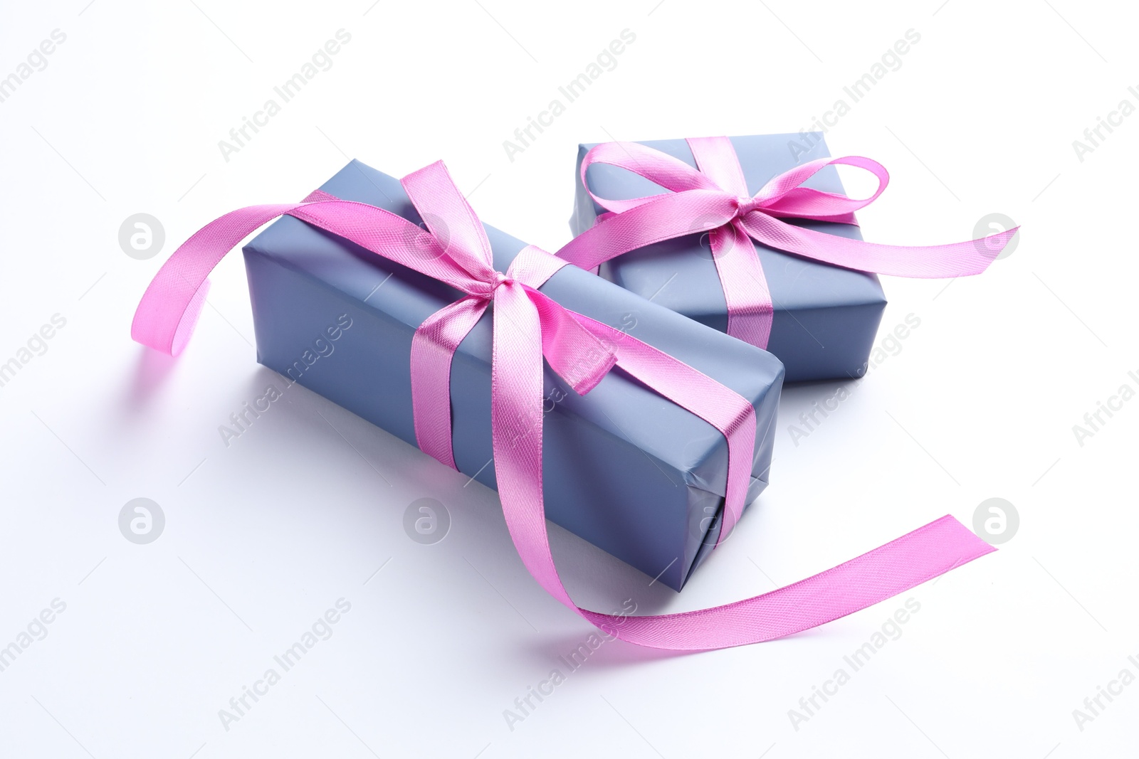 Photo of Beautiful gift boxes with pink bows isolated on white