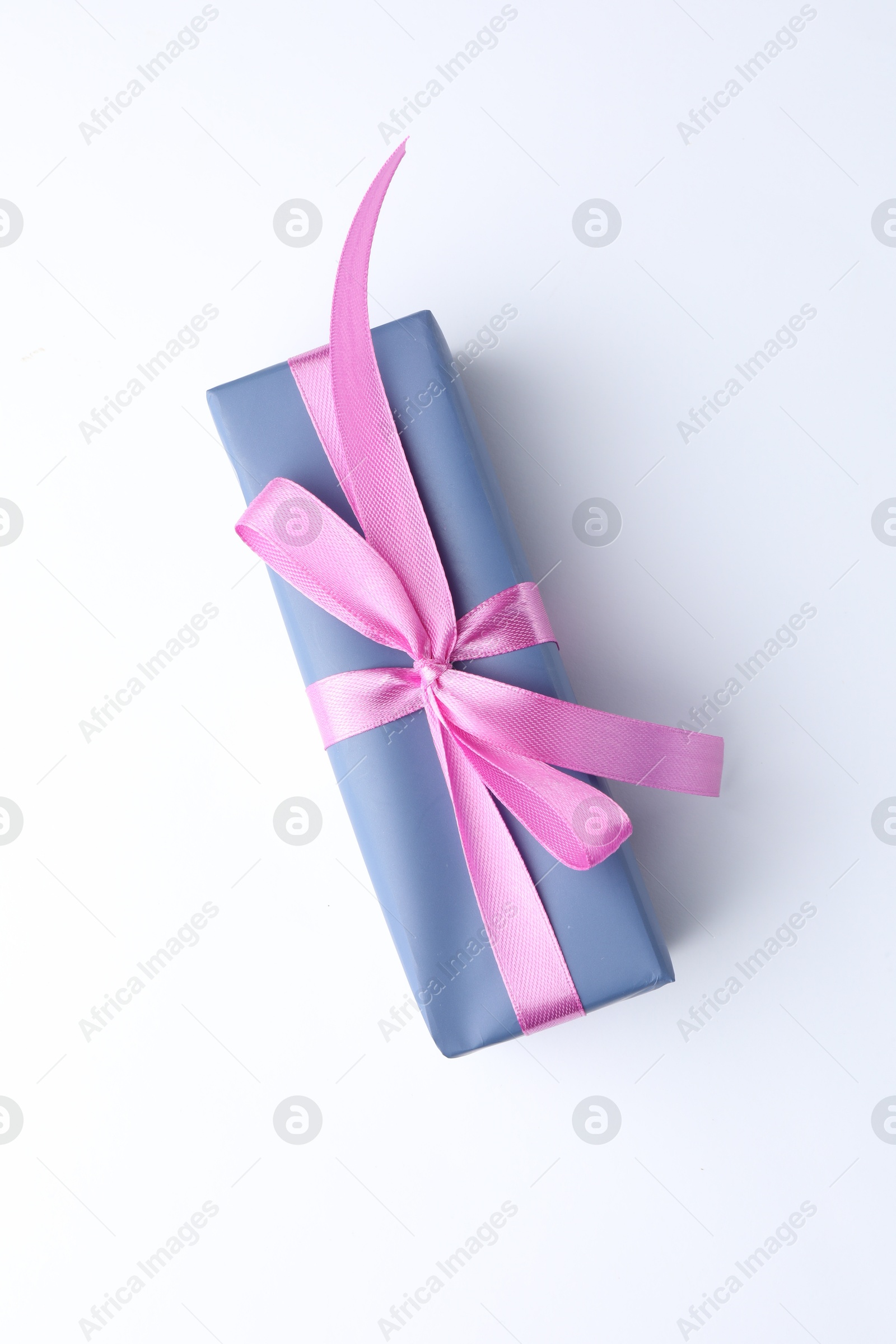 Photo of Beautiful gift box with pink bow isolated on white, top view