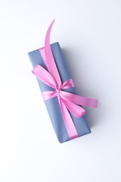 Photo of Beautiful gift box with pink bow isolated on white, top view