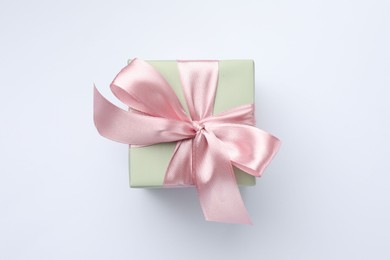 Photo of Beautiful gift box with pink bow isolated on white, top view