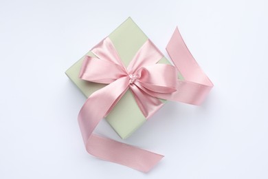 Photo of Beautiful gift box with pink bow isolated on white, top view