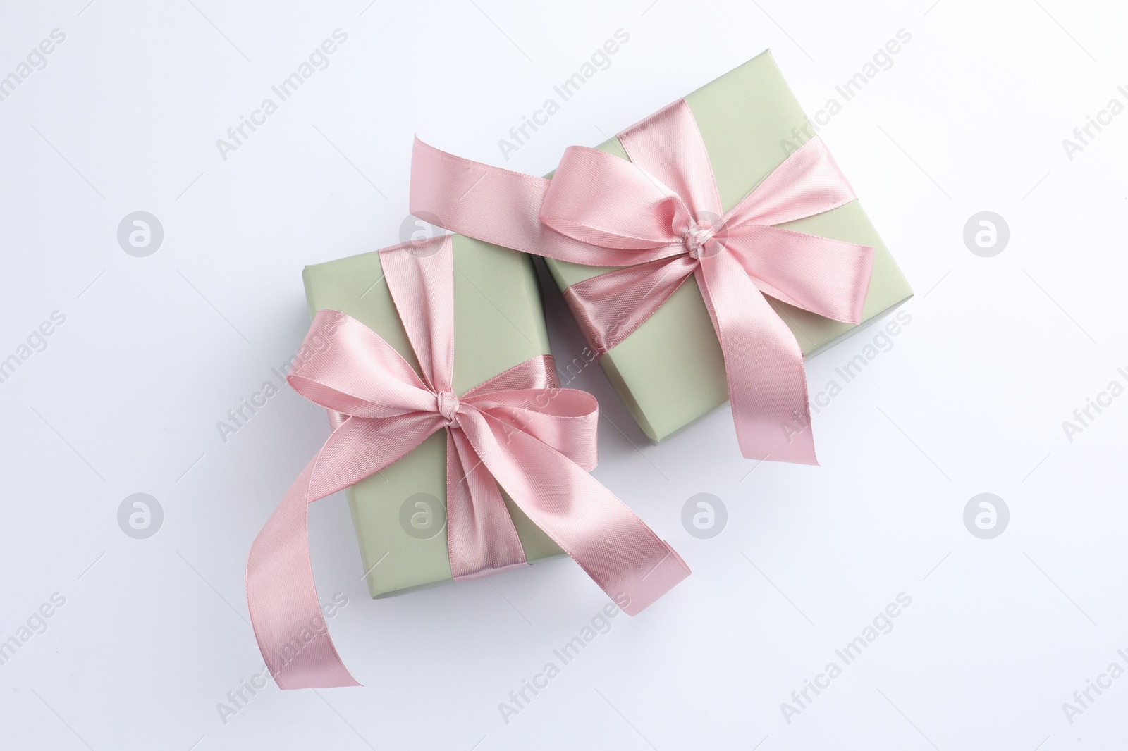 Photo of Beautiful gift boxes with pink bows isolated on white, top view