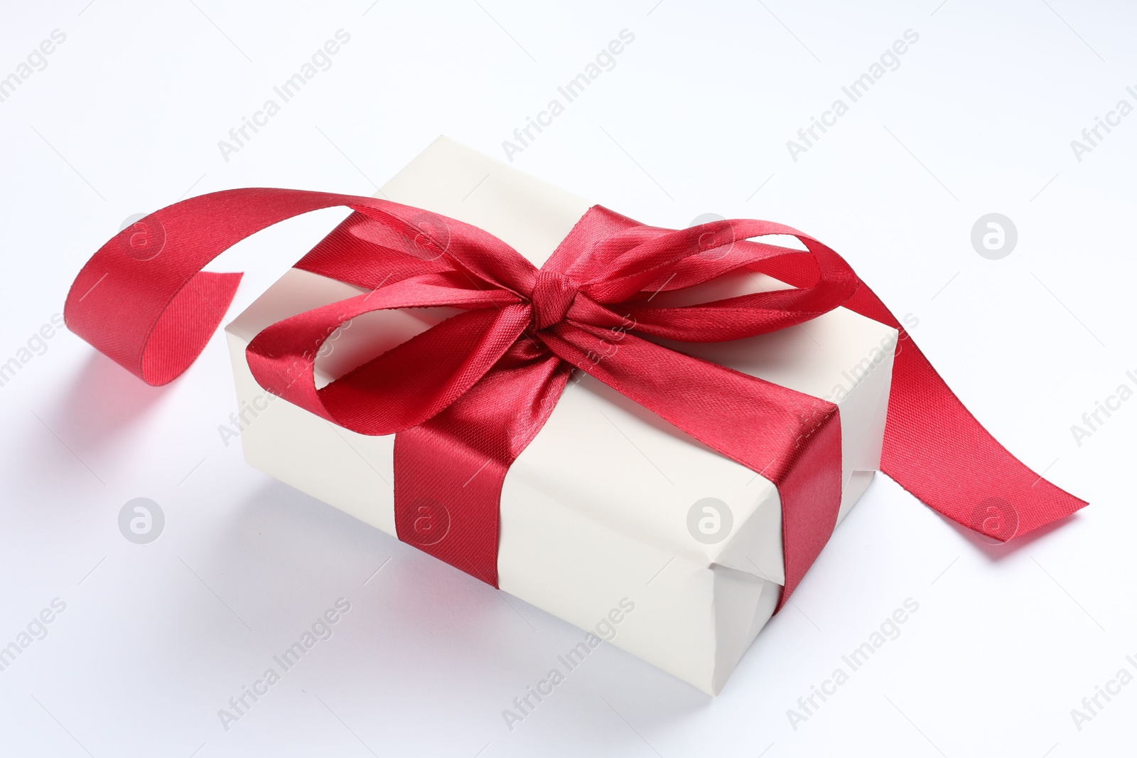 Photo of Beautiful gift box with red bow isolated on white