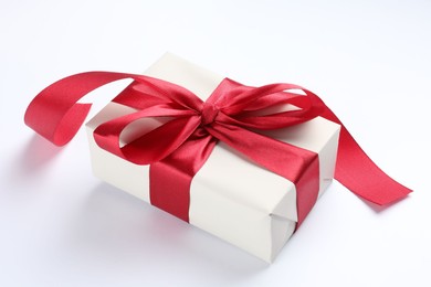 Photo of Beautiful gift box with red bow isolated on white