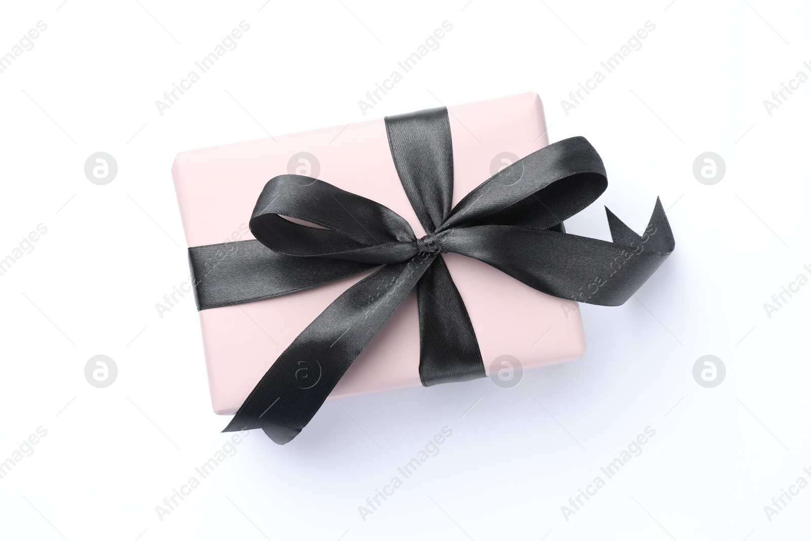 Photo of Beautiful gift box with black bow isolated on white, top view