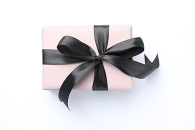 Photo of Beautiful gift box with black bow isolated on white, top view