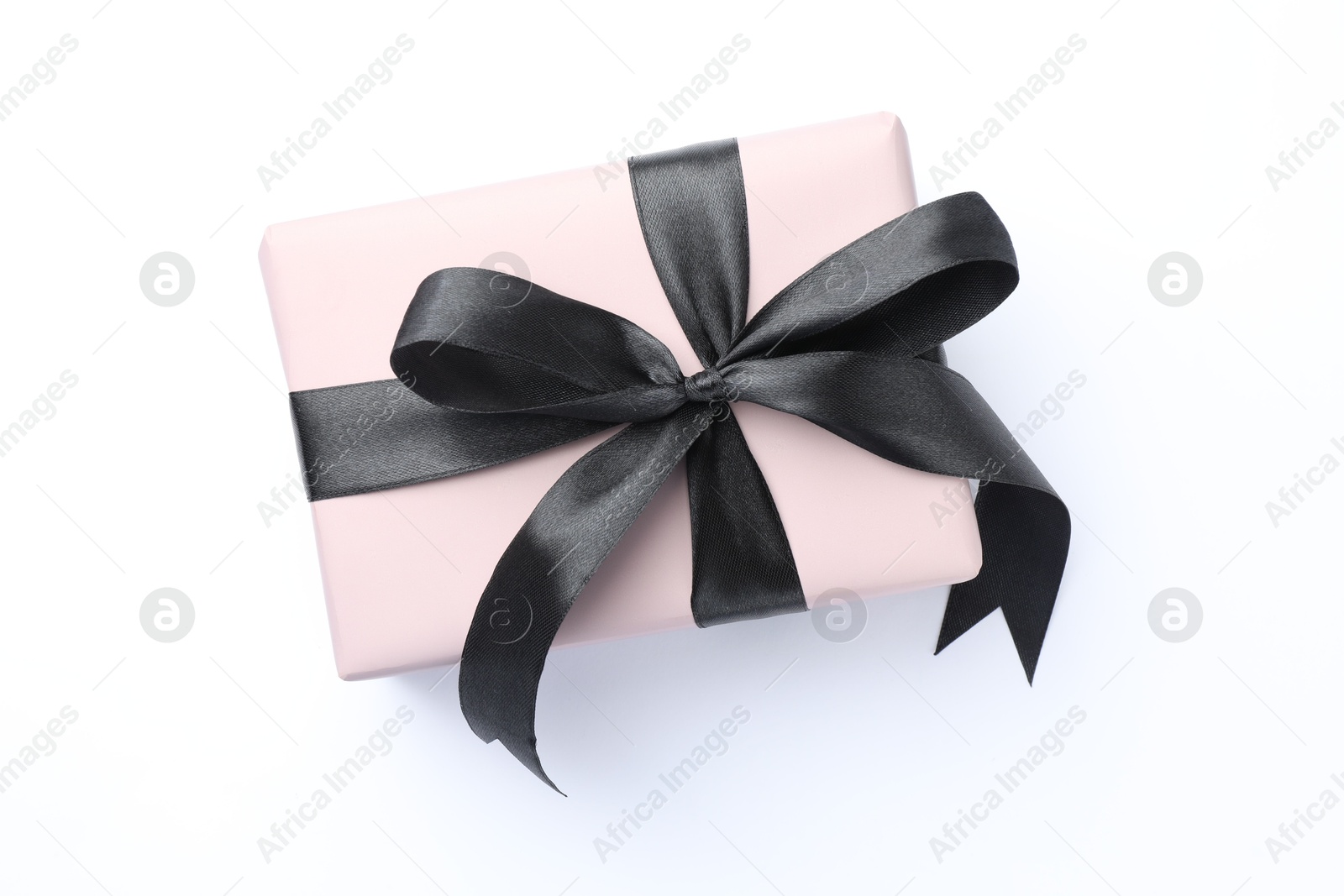 Photo of Beautiful gift box with black bow isolated on white, top view