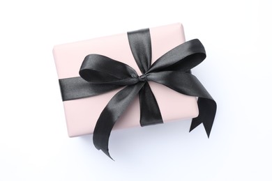 Photo of Beautiful gift box with black bow isolated on white, top view